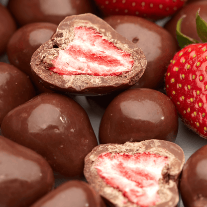 Geoeffnete NESSLIM Packung mit Erdbeeren in Vollmilchschokolade