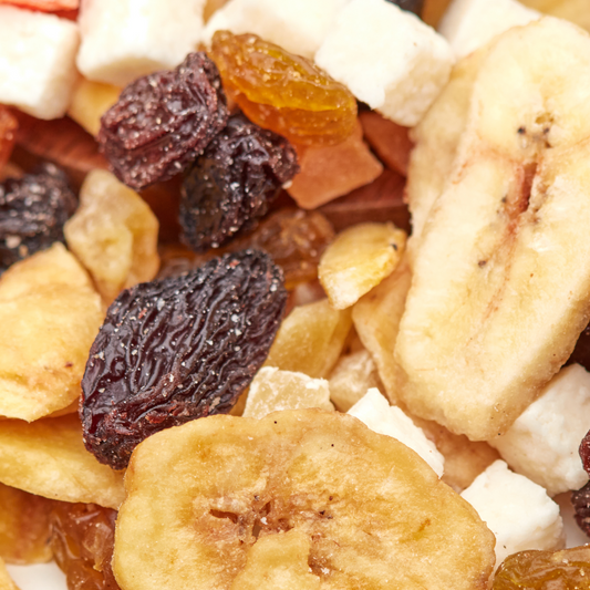 Makroaufnahme des Tropic Mix von NESSLIM mit Bananenchips, dunklen Rosinen und weißen Kokosstücken.
